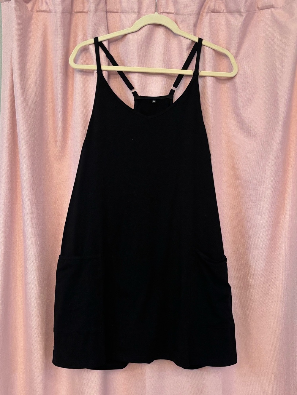 Women’s Romper dress with pockets and racerback detail.